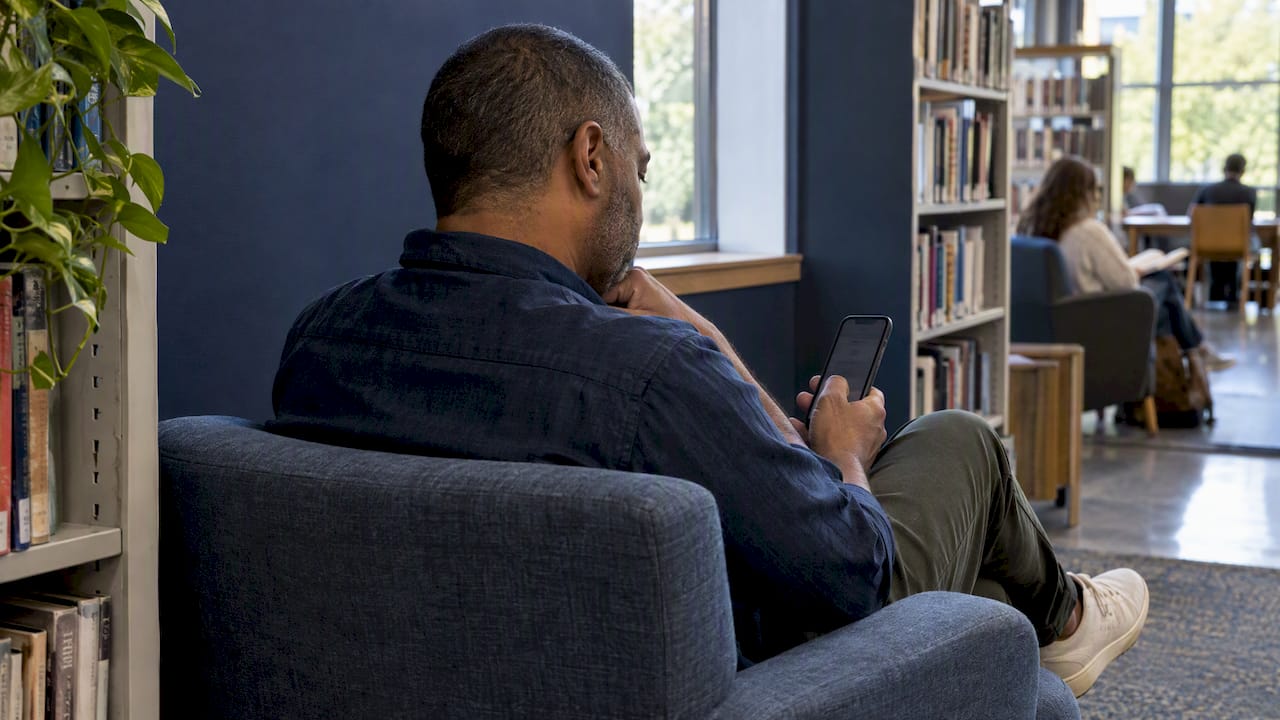 Voter reviewing a nominee profile on his phone